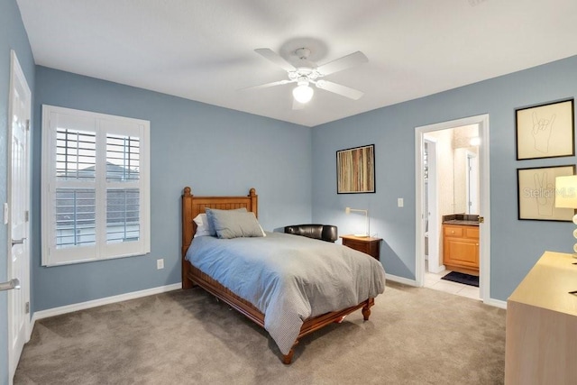 carpeted bedroom with connected bathroom and ceiling fan