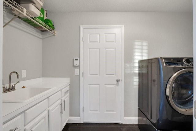 laundry room with washer / clothes dryer, sink, cabinets, and dark tile patterned flooring