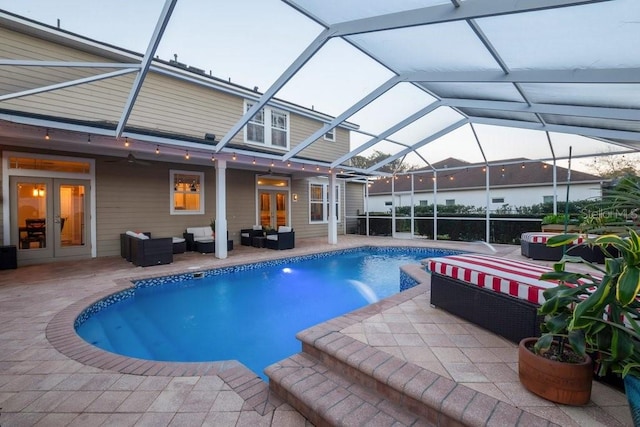 view of swimming pool with french doors, an outdoor hangout area, a lanai, and a patio area