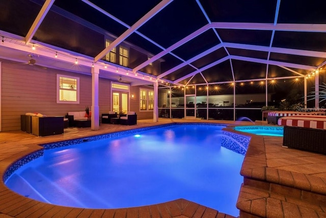 view of pool featuring a lanai, a hot tub, an outdoor hangout area, pool water feature, and a patio