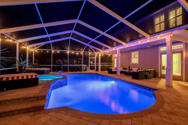 view of pool featuring an in ground hot tub, an outdoor hangout area, glass enclosure, and a patio area