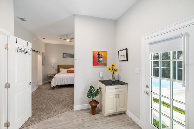 interior space with visible vents, ceiling fan, and baseboards