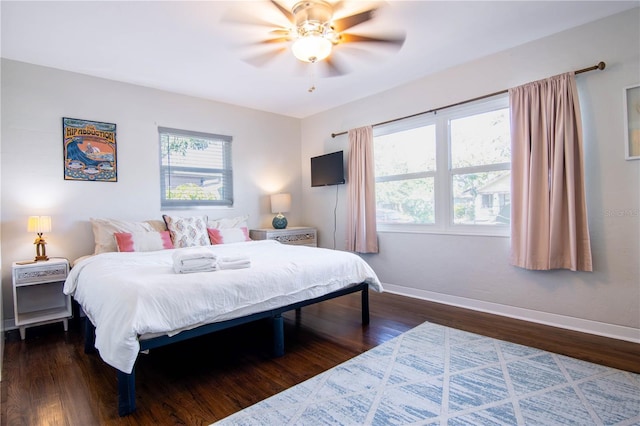 bedroom featuring dark wood-style floors, ceiling fan, and baseboards