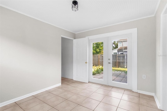 tiled empty room featuring ornamental molding and french doors