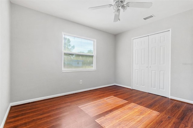 unfurnished bedroom featuring a closet, ceiling fan, and hardwood / wood-style flooring