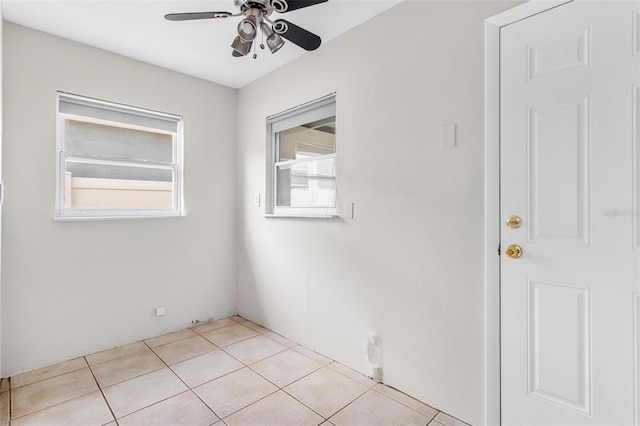 spare room with light tile patterned floors and ceiling fan