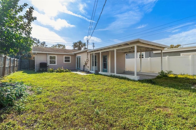 back of property featuring a lawn