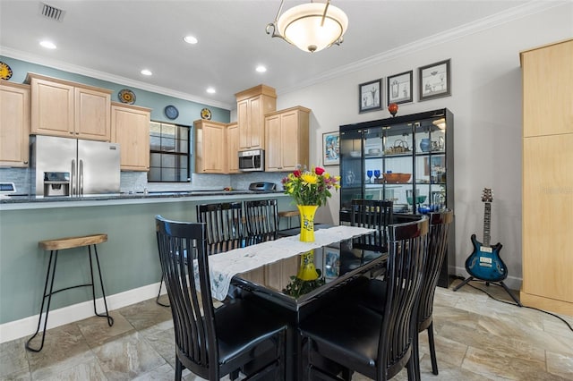 dining area featuring ornamental molding