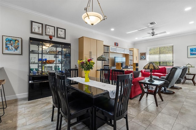 dining area featuring ceiling fan and crown molding