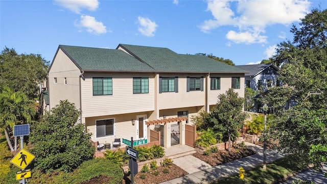 835 7th Ave N, Saint Petersburg, FL 33701 - view of property featuring stucco siding and roof with shingles