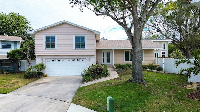 tri-level home with a front yard and a garage