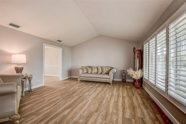 sitting room with lofted ceiling and light hardwood / wood-style flooring