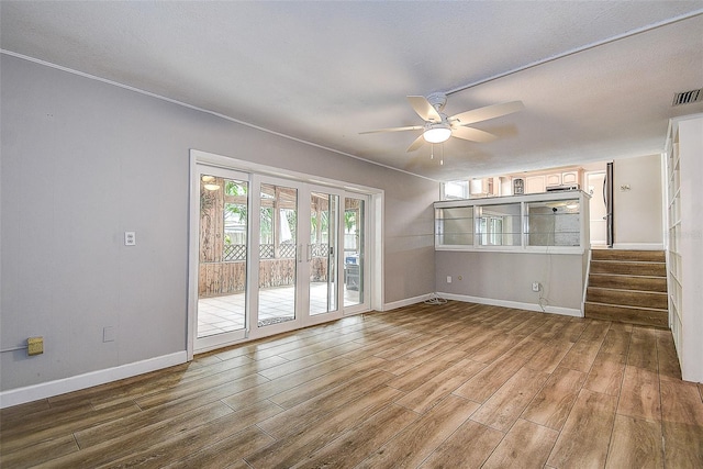 unfurnished living room with ceiling fan