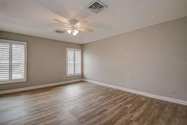 spare room with ceiling fan and light hardwood / wood-style floors