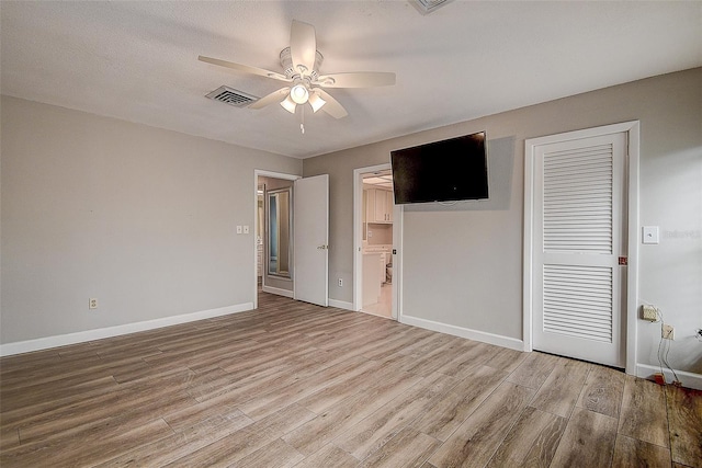 spare room featuring ceiling fan and light hardwood / wood-style flooring