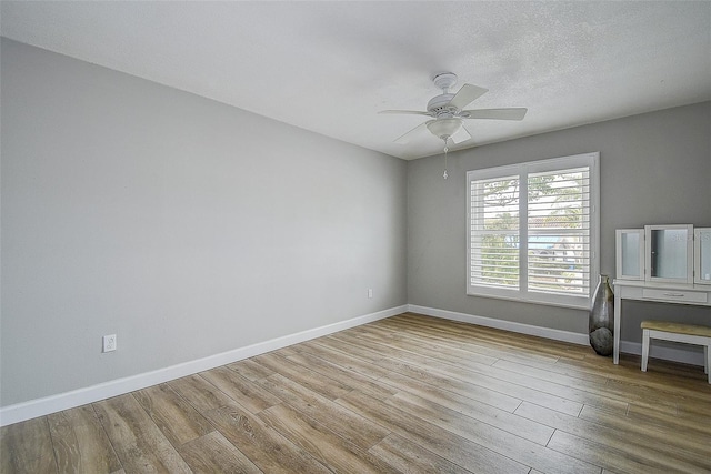 empty room featuring ceiling fan and light wood-type flooring