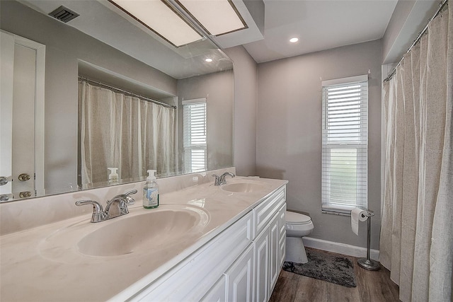 bathroom featuring hardwood / wood-style floors, vanity, and toilet