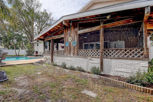 view of side of property featuring a fenced in pool