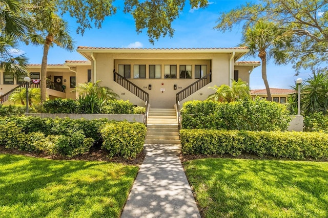 mediterranean / spanish home featuring a front yard