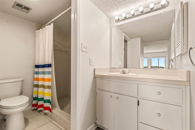 bathroom with tile patterned flooring, vanity, a textured ceiling, curtained shower, and toilet