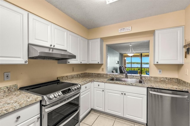 kitchen with extractor fan, sink, white cabinets, stainless steel appliances, and a textured ceiling