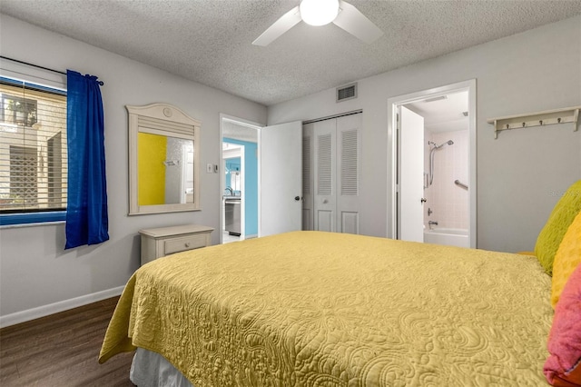 bedroom with multiple windows, wood-type flooring, a textured ceiling, and a closet