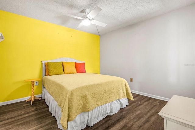 bedroom featuring dark wood-type flooring, ceiling fan, and a textured ceiling