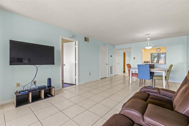 living room featuring light tile patterned floors and a textured ceiling