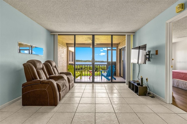 tiled living room with floor to ceiling windows and a textured ceiling