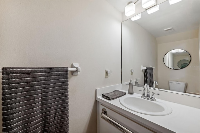 bathroom with vanity and toilet