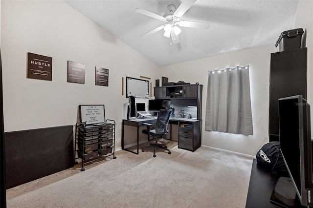 home office with ceiling fan, light colored carpet, lofted ceiling, and a textured ceiling