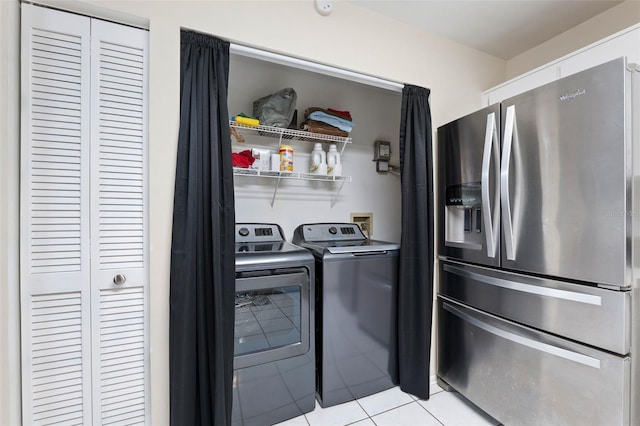 washroom with separate washer and dryer and light tile patterned floors