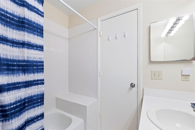 bathroom with sink and shower / bath combo with shower curtain