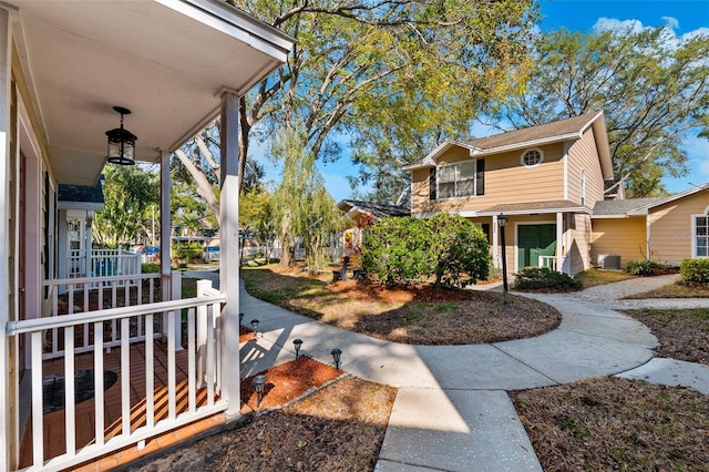 view of yard featuring central AC unit and covered porch