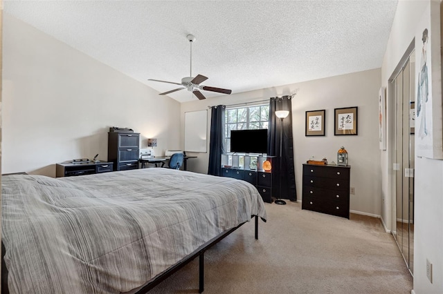 bedroom with light carpet, ceiling fan, vaulted ceiling, and a textured ceiling