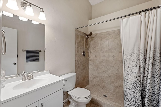 bathroom with vanity, toilet, and walk in shower