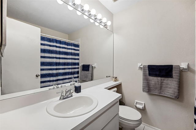 bathroom with vanity, curtained shower, and toilet