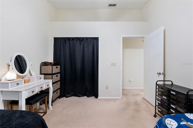 bedroom featuring light colored carpet