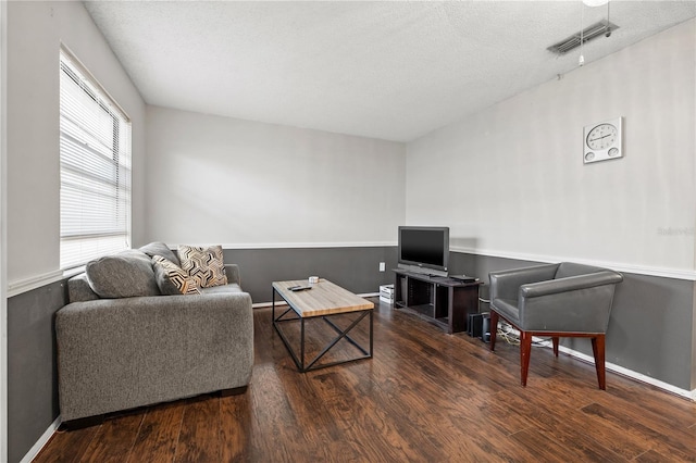 interior space with dark wood-type flooring and a textured ceiling