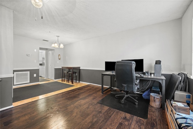 office area with hardwood / wood-style floors, a textured ceiling, and a notable chandelier