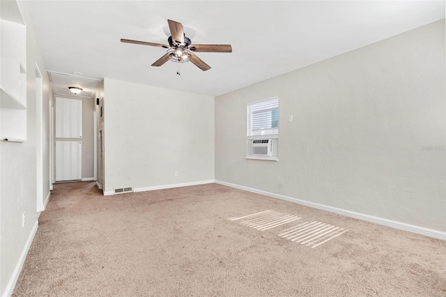 carpeted spare room featuring ceiling fan and cooling unit