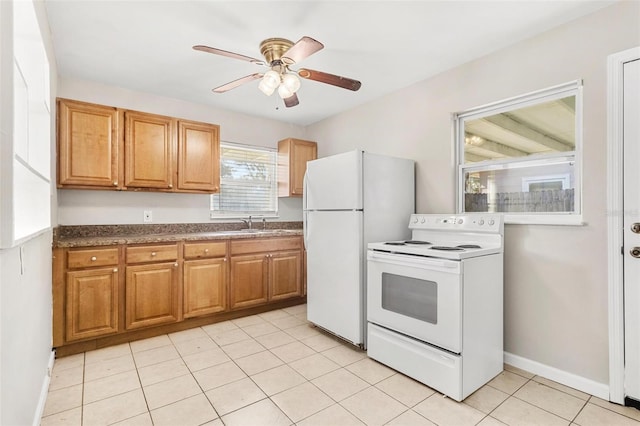 kitchen featuring light tile patterned floors, white appliances, ceiling fan, and sink