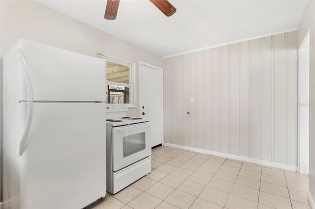 kitchen with light tile patterned floors, white appliances, ceiling fan, and wood walls