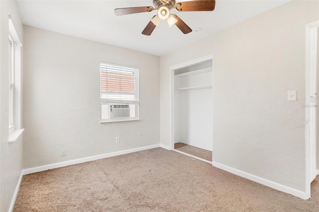 unfurnished bedroom with carpet floors, a closet, ceiling fan, and cooling unit