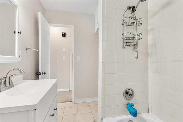 bathroom featuring tile patterned flooring, vanity, and tiled shower / bath