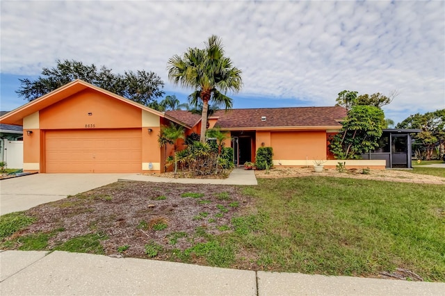 ranch-style home with a front yard, a garage, and a sunroom