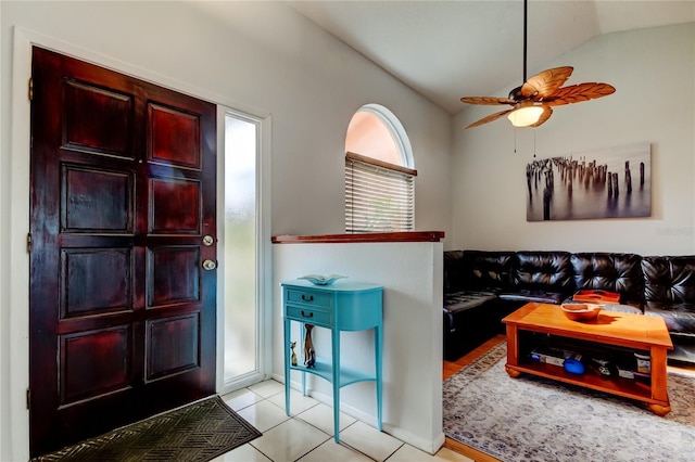 tiled living room featuring ceiling fan and lofted ceiling