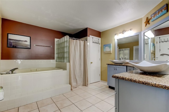 bathroom featuring tile patterned floors, vanity, and shower with separate bathtub