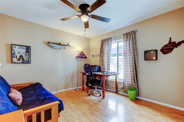 office space featuring a textured ceiling, hardwood / wood-style flooring, and ceiling fan