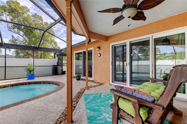 view of pool with a lanai, ceiling fan, and a patio